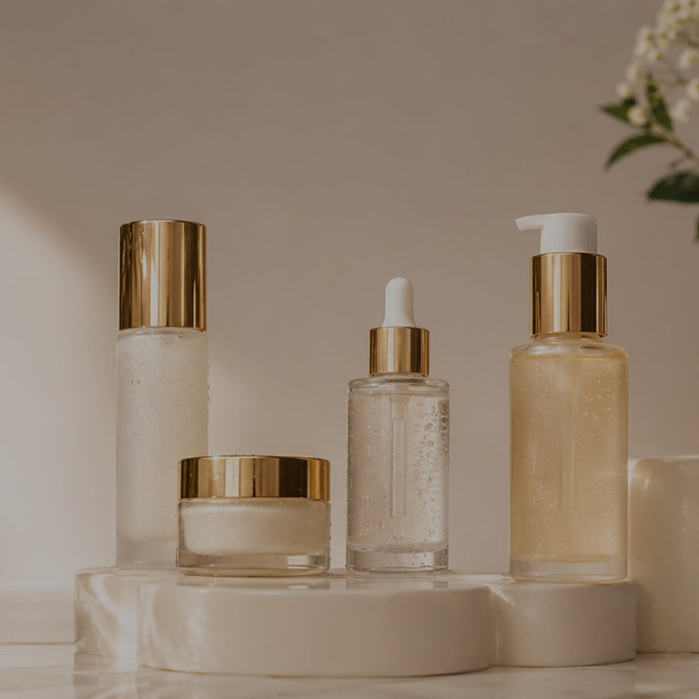 Set of skincare products on a neutral background with plants